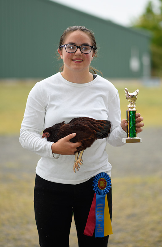 Amy holding a hen and a trophy